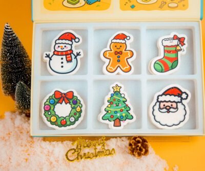 Christmas Friends sponge gift set displayed with Doyourclean box, featuring festive designs like Santa, wreath, and snowman.