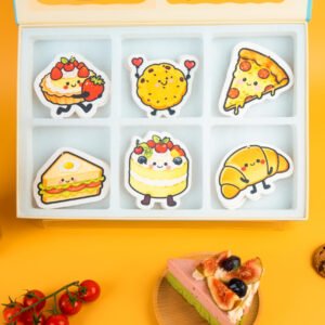 Doyourclean Bakery Friends Collection – 6 Designs, 18 Sponges Bakery Friends eco sponge set displayed with pastries and cookies, featuring all six designs and branded box.