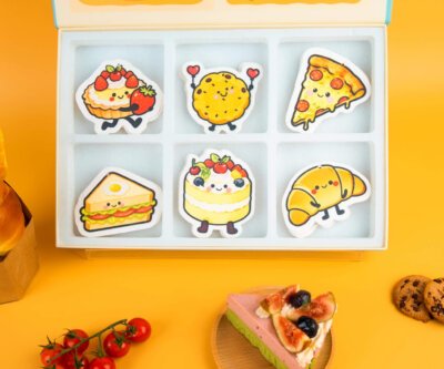 Bakery Friends eco sponge set displayed with pastries and cookies, featuring all six designs and branded box.