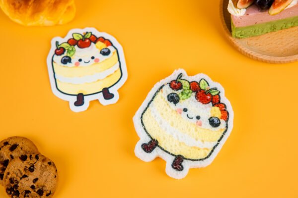 Bakery Friends â Cake Biodegradable Sponge | Doyourclean Cake-shaped cellulose sponges from Doyourclean Bakery Friends collection with dessert props on yellow background.