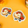 Bakery Friends â Strawberry Tart Biodegradable Sponge | Doyourclean Strawberry tart-shaped cellulose sponges on yellow surface with bread and cookie props.