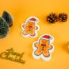 Christmas Friends â Gingerbread Man Biodegradable Sponge | Doyourclean Gingerbread man-shaped cellulose sponge photographed with pine decor and gold ornaments.