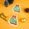 Santa Friends â Christmas Tree Sponge | Biodegradable Holiday Collection Christmas tree-shaped cellulose sponge with gold ornaments and mini pinecones on yellow background.