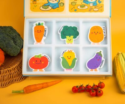 Different angle of Doyourclean Vegetable Friends cellulose sponge box surrounded by vegetables.