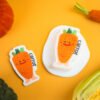 Vegetable Friends â Carrot Eco Sponge | Cute Sustainable Cleaning Orange carrot-shaped Doyourclean cellulose sponge with smiling face.