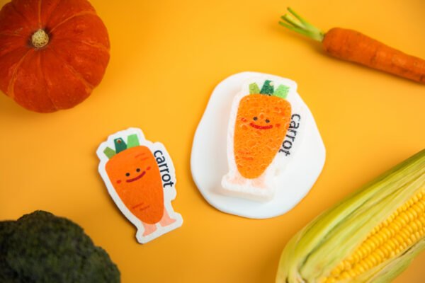 Vegetable Friends â Carrot Eco Sponge | Cute Sustainable Cleaning Orange carrot-shaped Doyourclean cellulose sponge with smiling face.