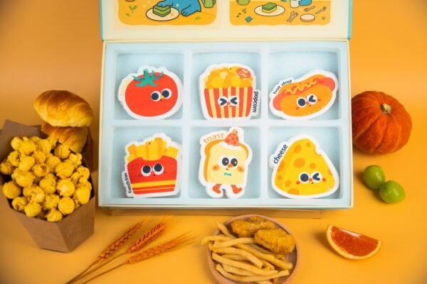 Tasty Friends Sponge Set â Cute Biodegradable Kitchen Gift Another angle of Doyourclean Tasty Friends cellulose sponge set with yellow background and popcorn props.
