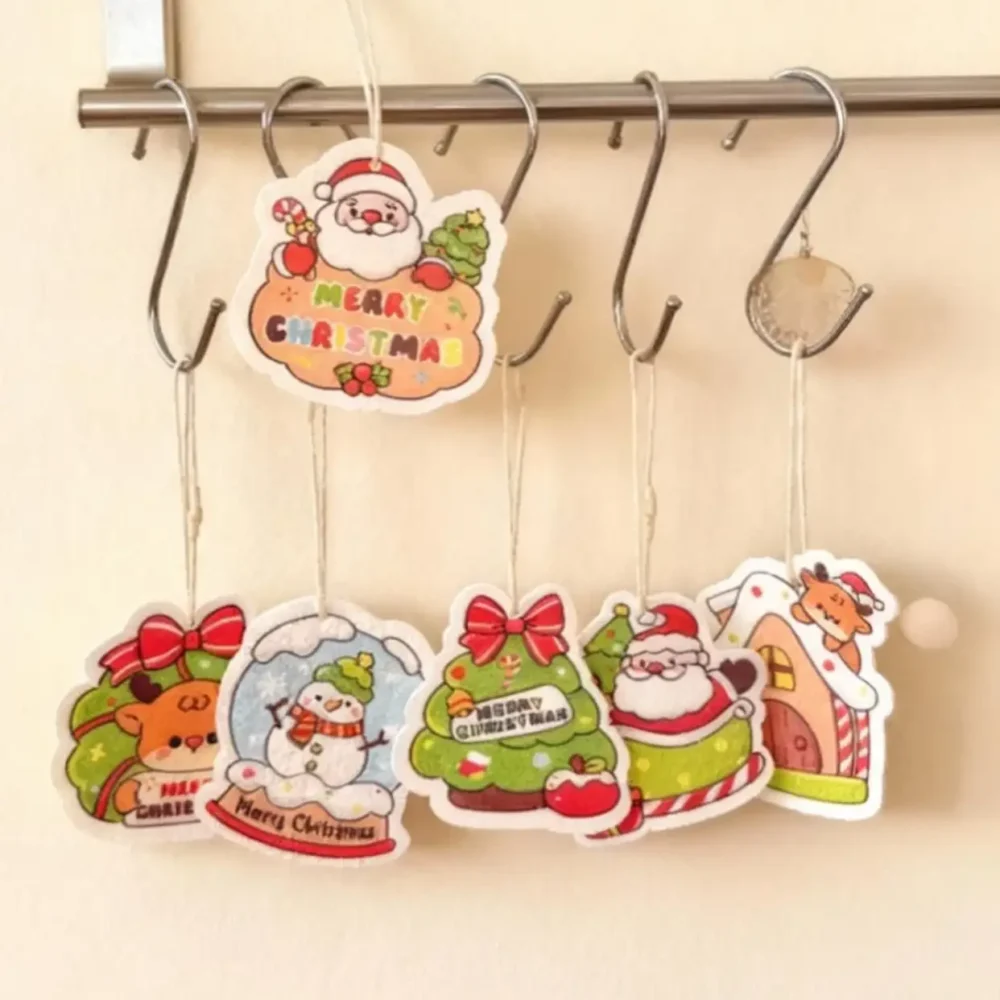 Multiple Santa Friends cellulose sponges hanging by their cords on a rail to dry, showing quick-drain storage.