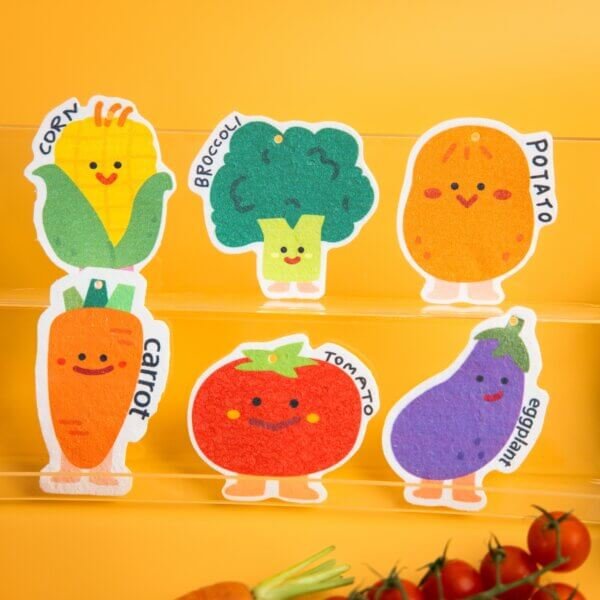 Vegetable Friends â Cute Veggie Sponge Set | Biodegradable Eco Sponges Doyourclean Vegetable Friends sponges featuring broccoli, corn, carrot, tomato, eggplant, and potato characters, neatly arranged with fresh veggie props.
